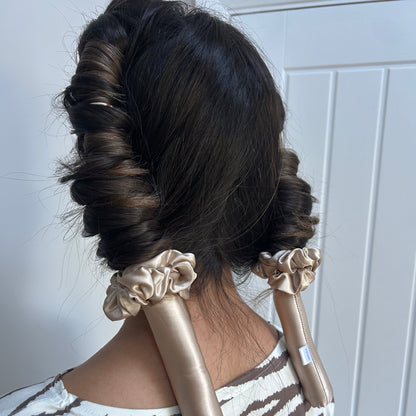Model wearing the Haus Gio silk heatless curler in her hair, demonstrating how the curler wraps the hair gently to create soft, voluminous curls without heat.